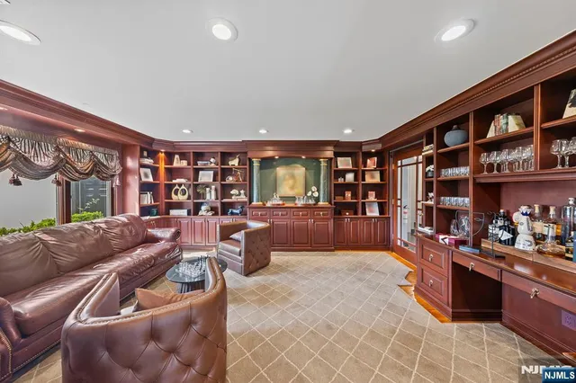 a living room with fireplace furniture and a book shelf