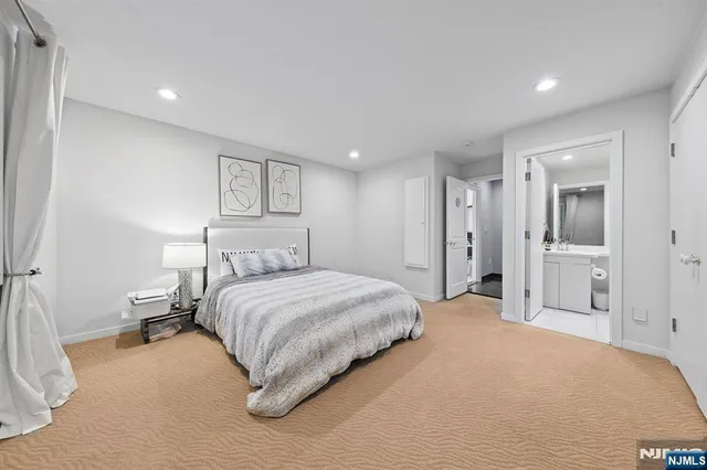a spacious bedroom with a bed and a walk in closet