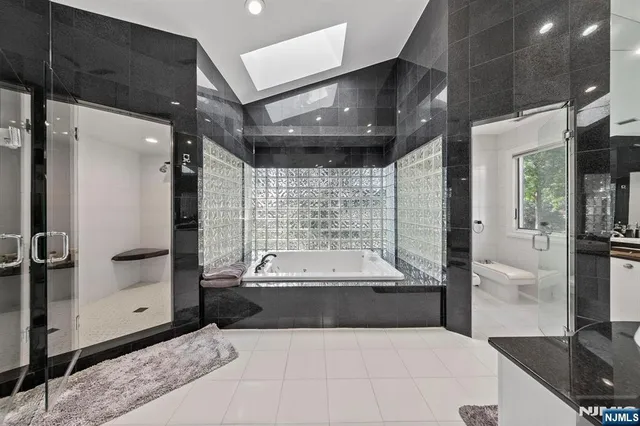 a spacious bathroom with a large tub and shower