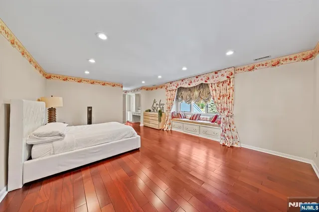 a spacious bedroom with a bed and a large window