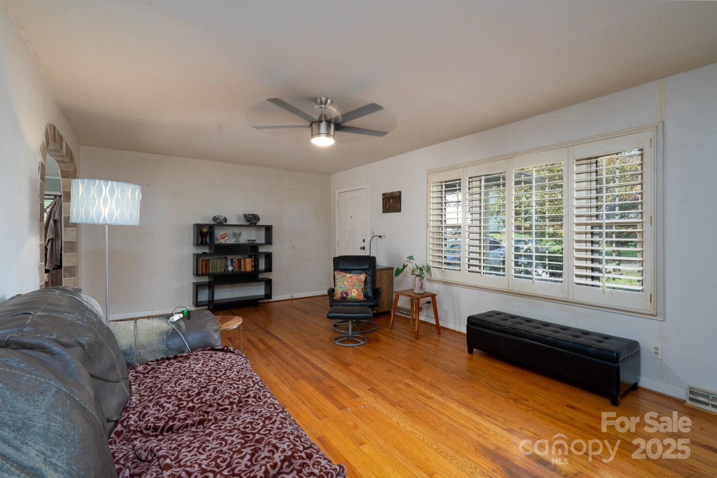 702 Rhodes Avenue Kings Mountain, NC 28086 - Photo 5 of 17 a living room with furniture and a chandelier
