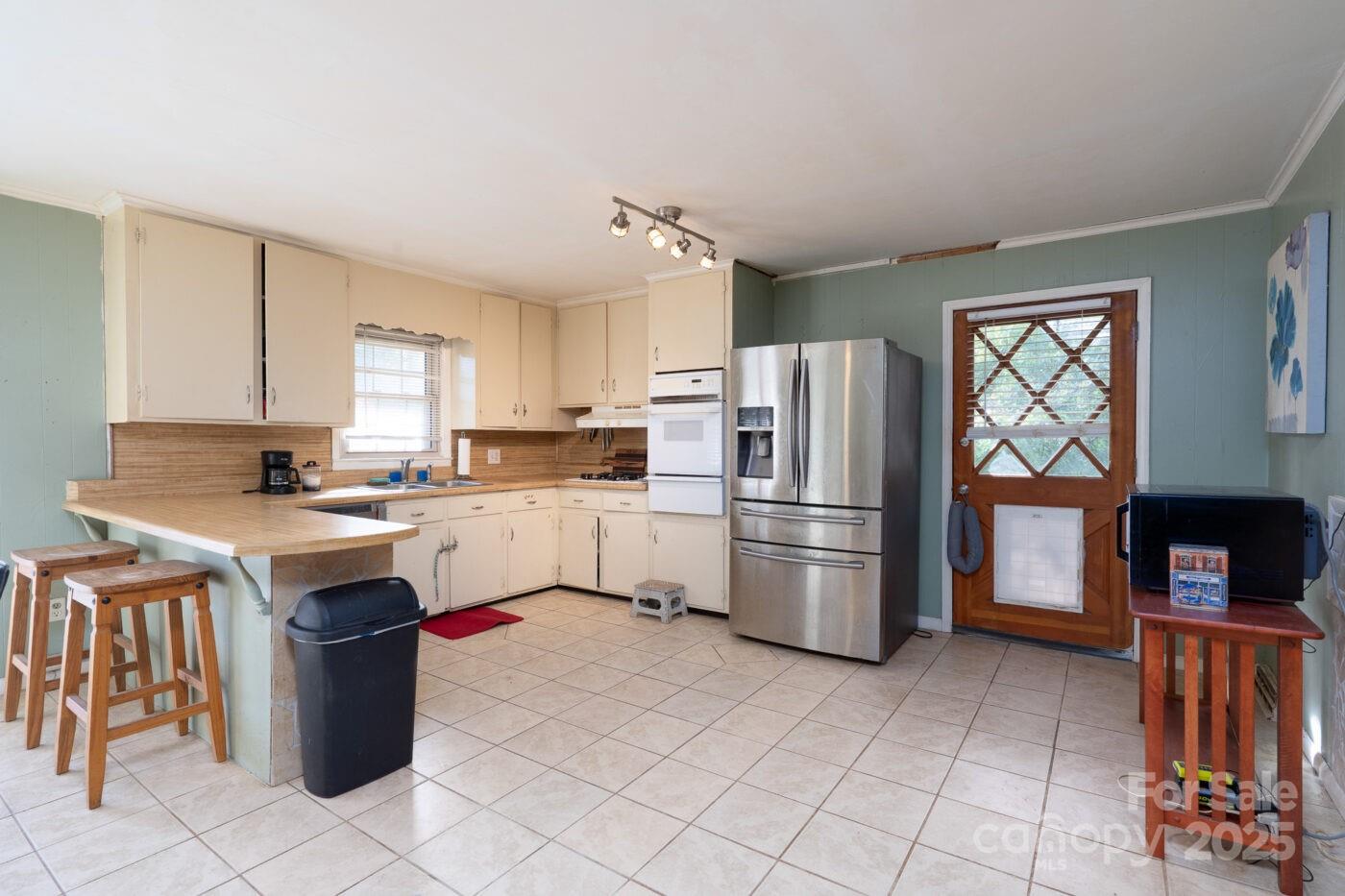 702 Rhodes Avenue Kings Mountain, NC 28086 - Photo 9 of 17 a kitchen with a refrigerator sink and stove