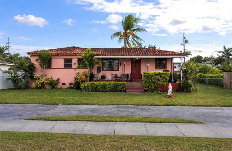 8330 Southwest 27th Terrace Miami, FL 33155 - Photo 1 of 2 a front view of a house with a garden and yard