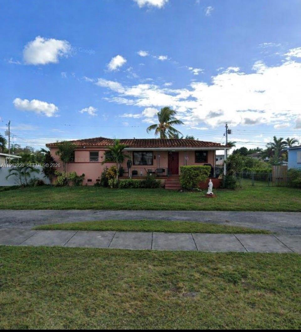 8330 Southwest 27th Terrace Miami, FL 33155 - Photo 2 of 2 a front view of a house with a yard