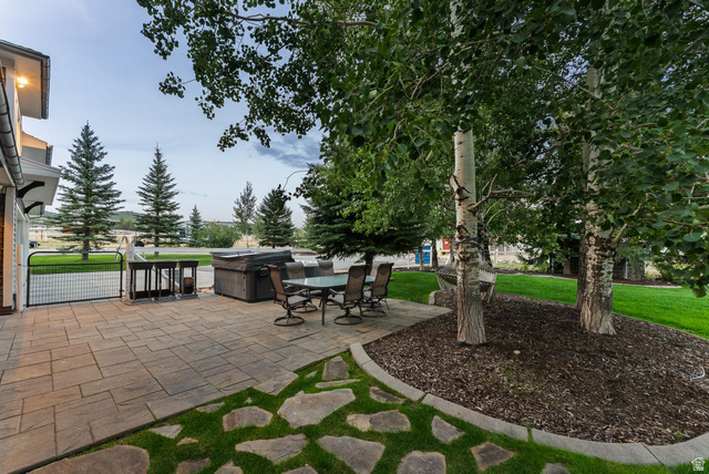 8650 Redden Road Park City, UT 84098 - Photo 38 of 71 Expansive paver patio with a stone path, lush lawn, and mature trees