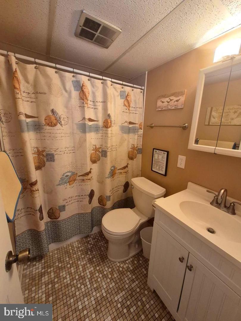 745 Mooring Road, Unit 103 Ocean City, MD 21842 - Photo 13 of 14 a bathroom with a sink toilet and shower