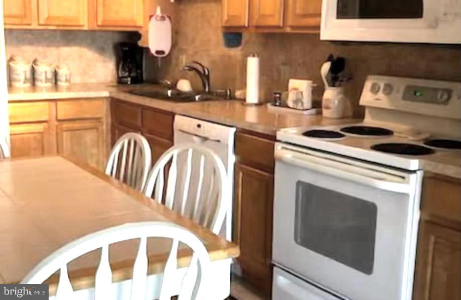 745 Mooring Road, Unit 103 Ocean City, MD 21842 - Photo 3 of 14 a kitchen with stainless steel appliances granite countertop a stove and a sink