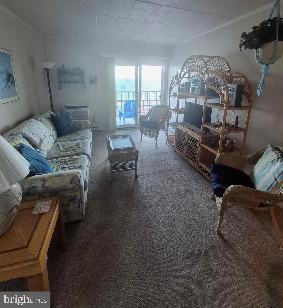 745 Mooring Road, Unit 103 Ocean City, MD 21842 - Photo 5 of 14 a living room with furniture and a chandelier