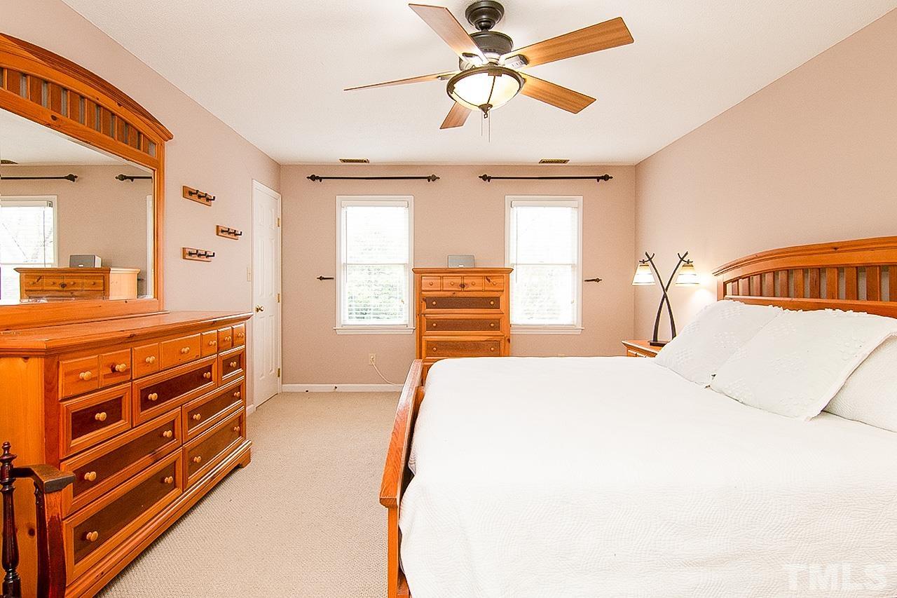 7300 Quinby Court Raleigh, NC 27613 - Photo 15 of 29 a bedroom with a bed and a dresser