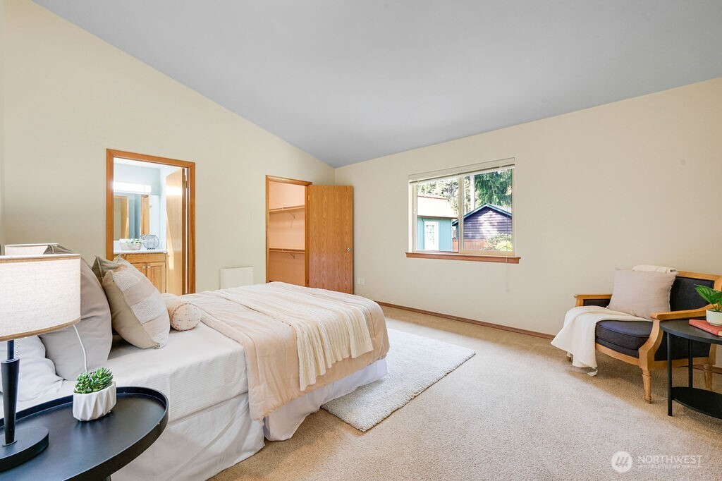 4919 Bell Street Port Townsend, WA 98368 - Photo 29 of 40 a bedroom with a bed and wooden floor