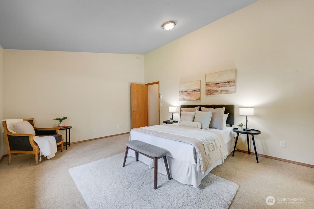 4919 Bell Street Port Townsend, WA 98368 - Photo 31 of 40 a bedroom with a bed and a chair