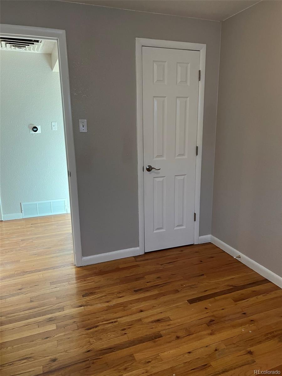 1245 Yates Street Denver, CO 80204 - Photo 11 of 24 a view of an empty room with wooden floor