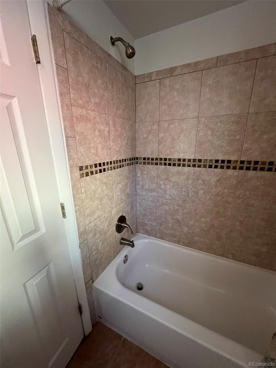 1245 Yates Street Denver, CO 80204 - Photo 14 of 24 a bathroom with a shower and a bath tub