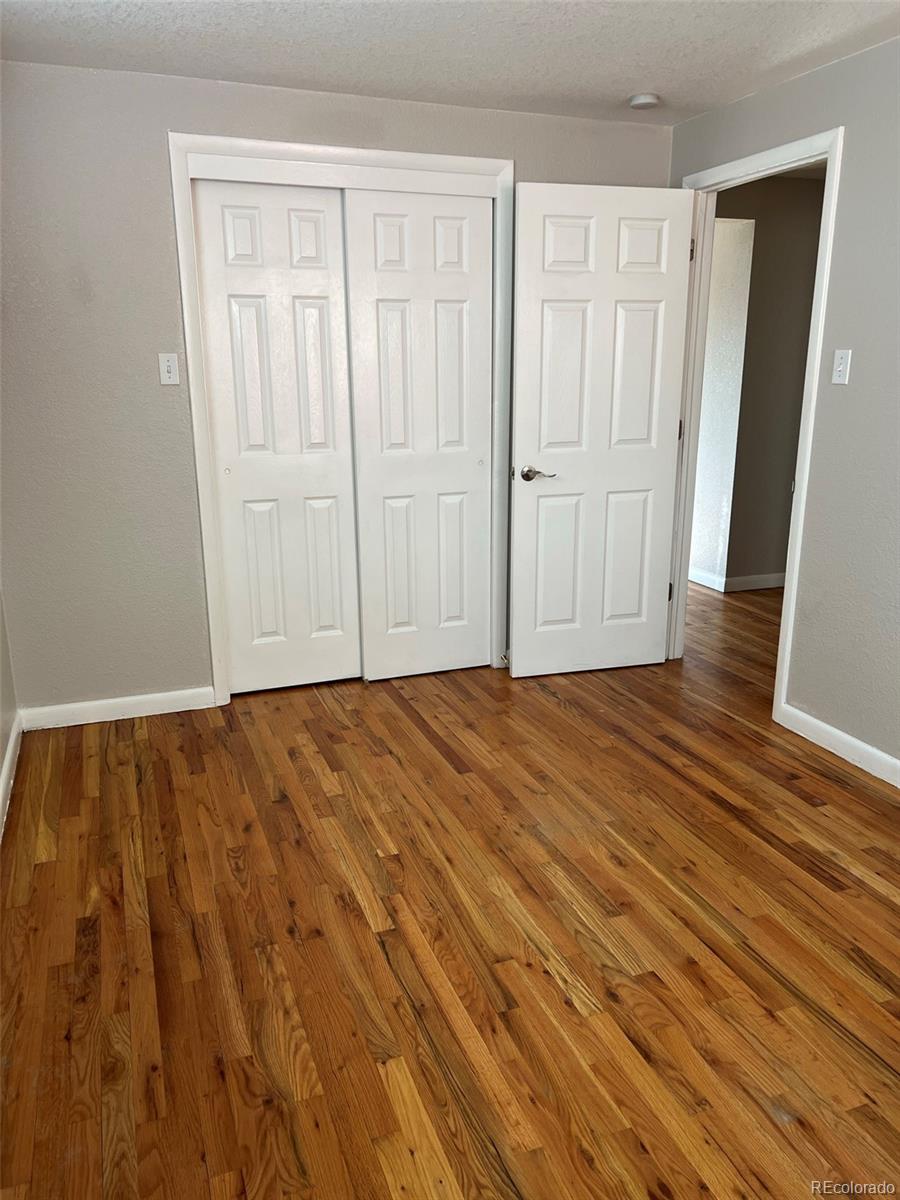 1245 Yates Street Denver, CO 80204 - Photo 7 of 24 a view of empty room with wooden floor