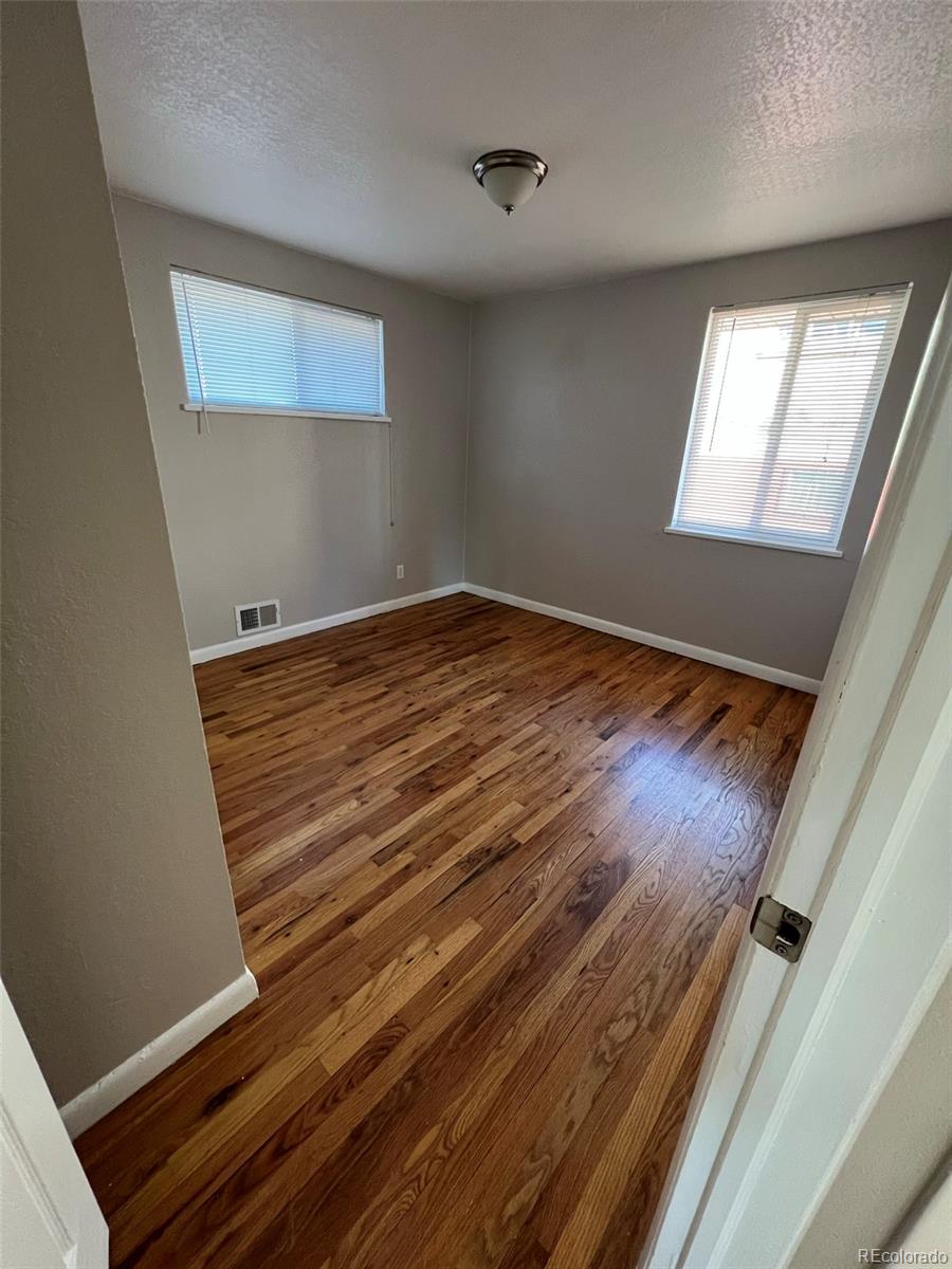 1245 Yates Street Denver, CO 80204 - Photo 8 of 24 a view of a room with wooden floor and staircase