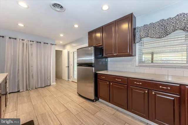a kitchen with stainless steel appliances granite countertop a refrigerator and a sink