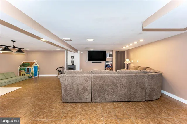 a living room with furniture and a lamp