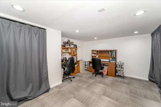 a bathroom with a granite countertop toilet a sink and a mirror