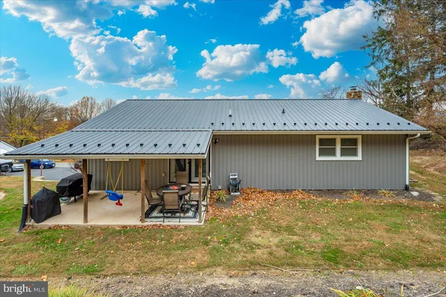 a view of a house with backyard porch and sitting area