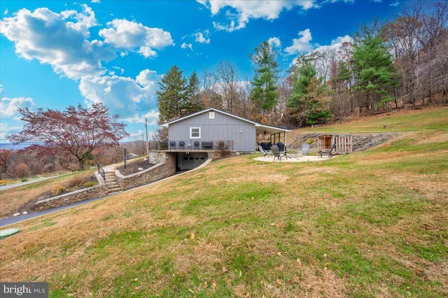 a view of a house with backyard and sitting area
