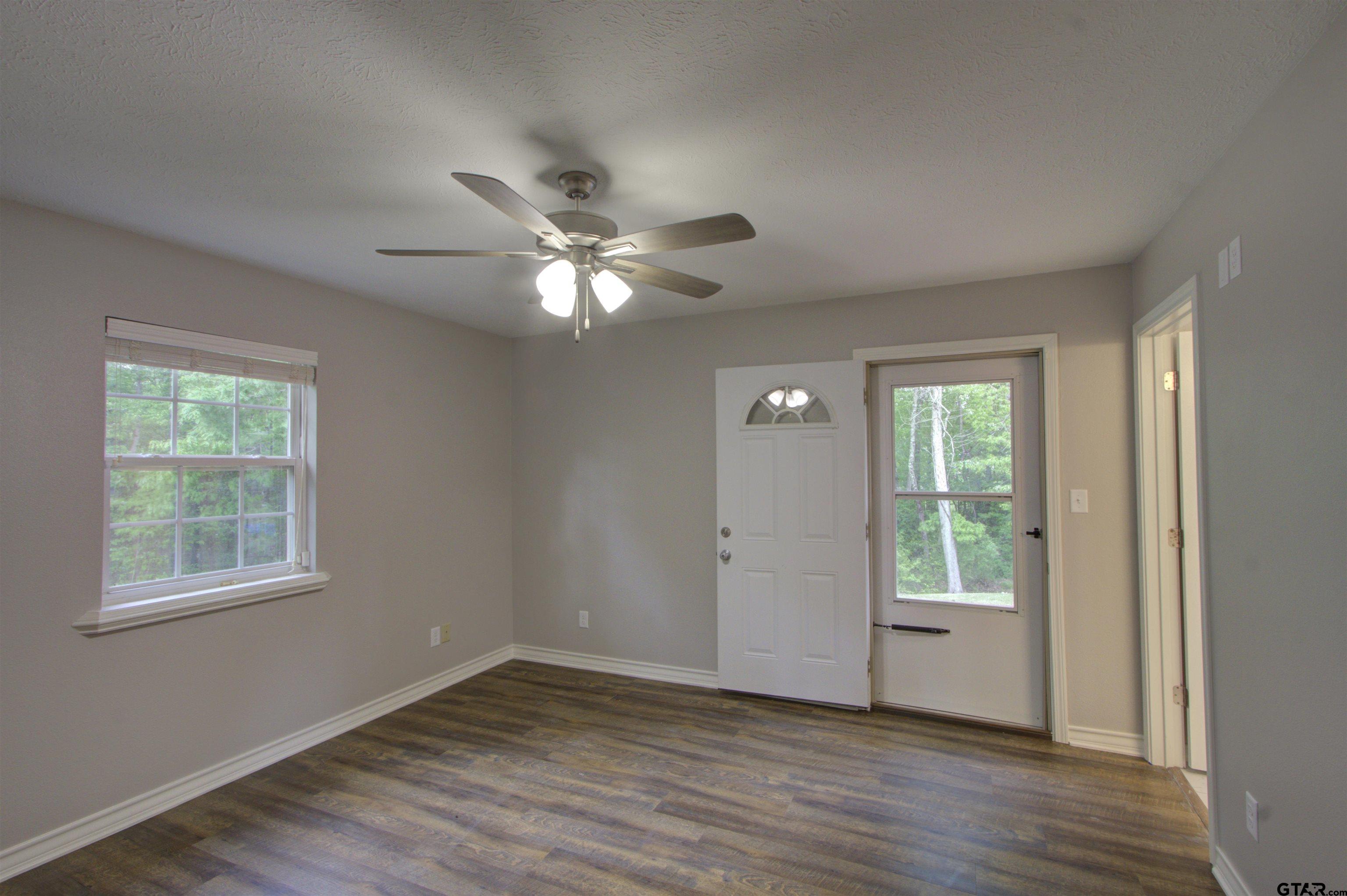 720 Tennessee Acres Drive Texarkana Ar, AR 71854 - Photo 11 of 31 a view of an empty room with a window and wooden floor