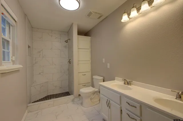 a bathroom with a sink toilet and shower