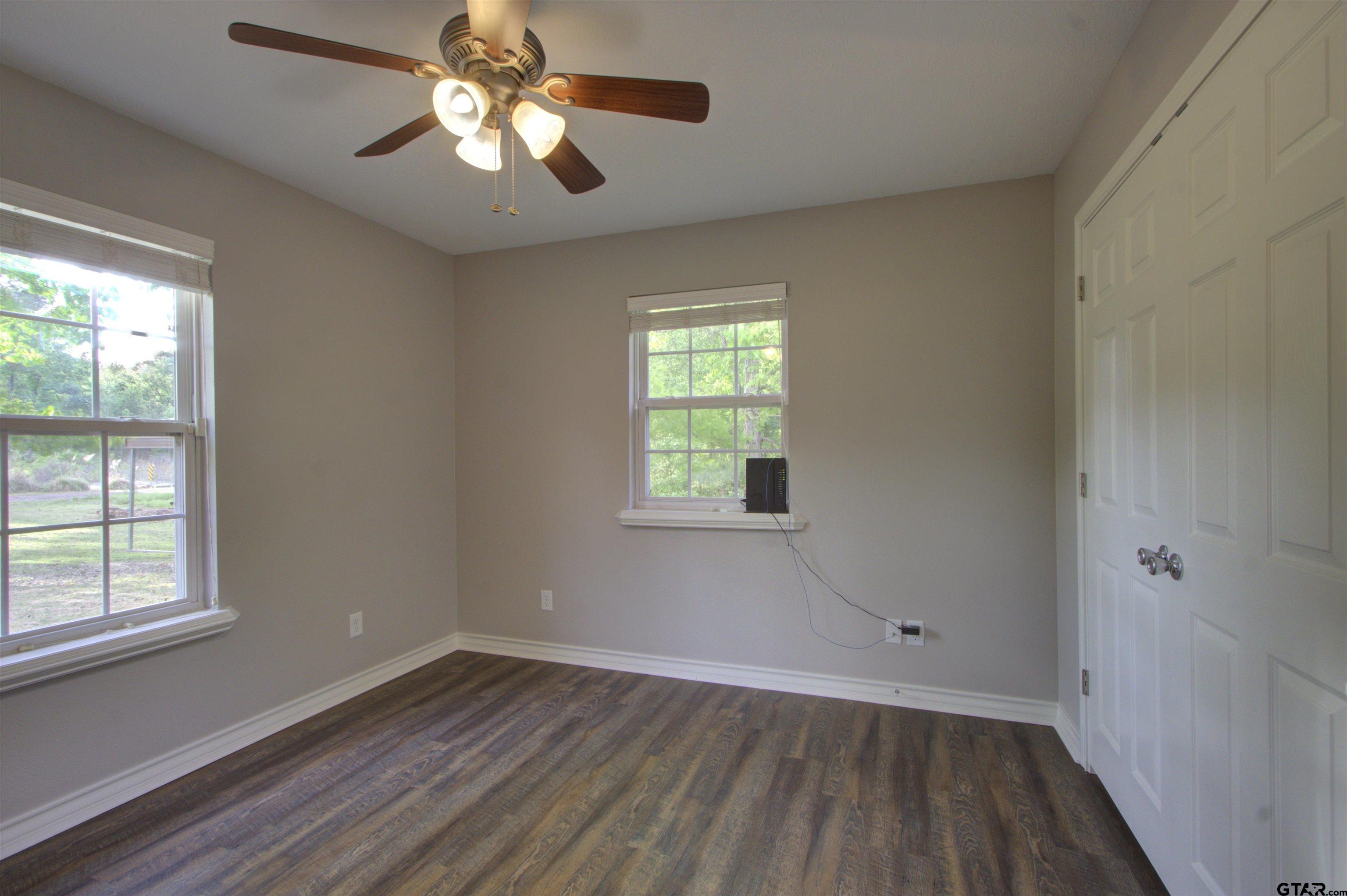 720 Tennessee Acres Drive Texarkana Ar, AR 71854 - Photo 15 of 31 wooden floor in an empty room with a window