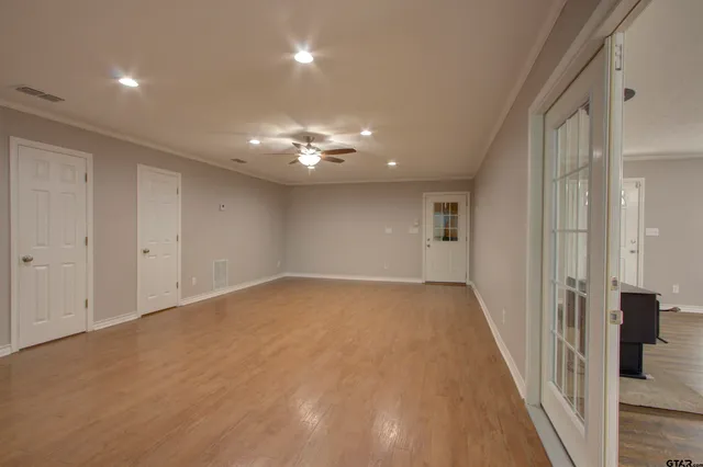 wooden floor in an empty room with a mirror