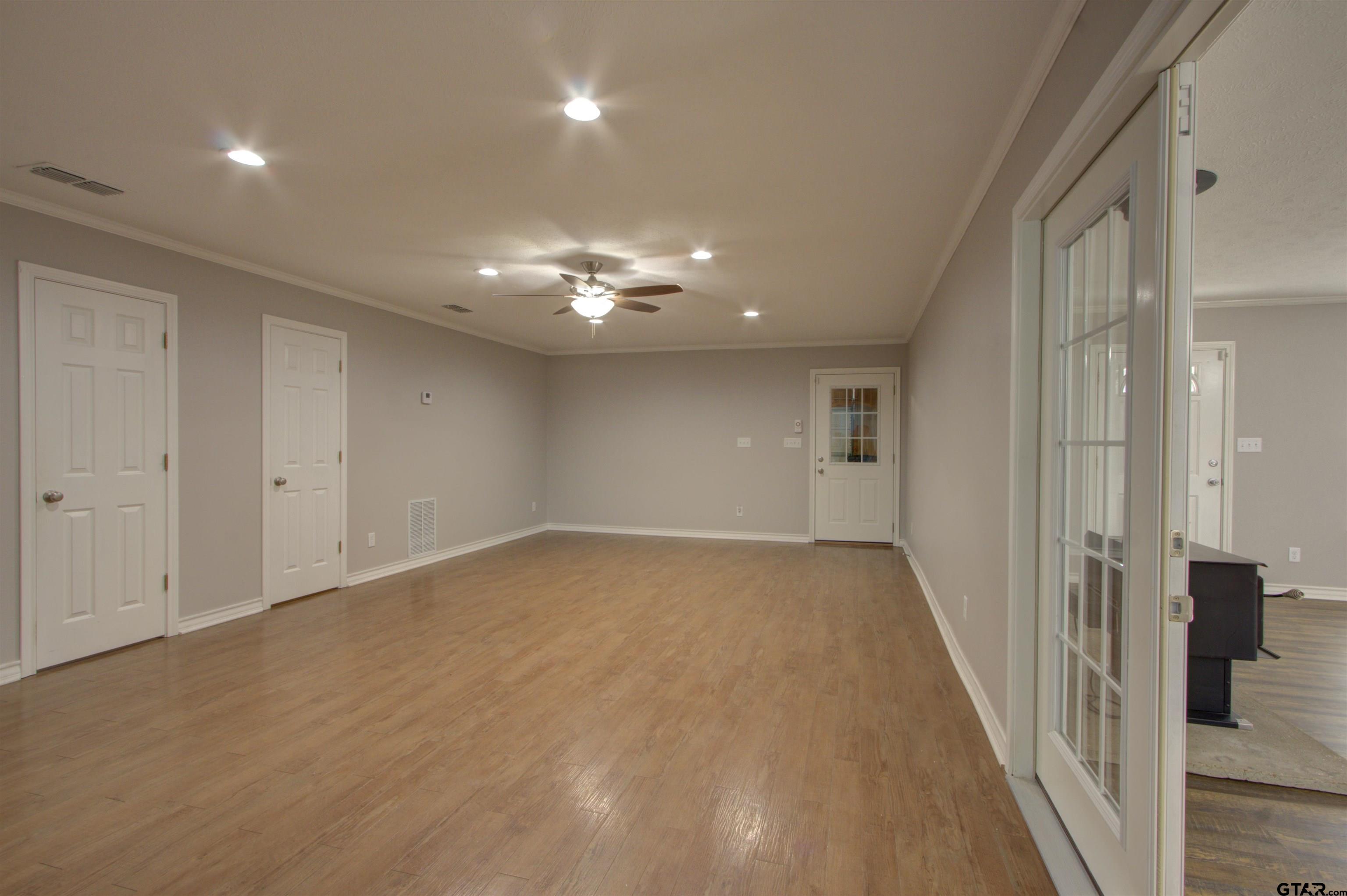 720 Tennessee Acres Drive Texarkana Ar, AR 71854 - Photo 19 of 31 wooden floor in an empty room with a mirror