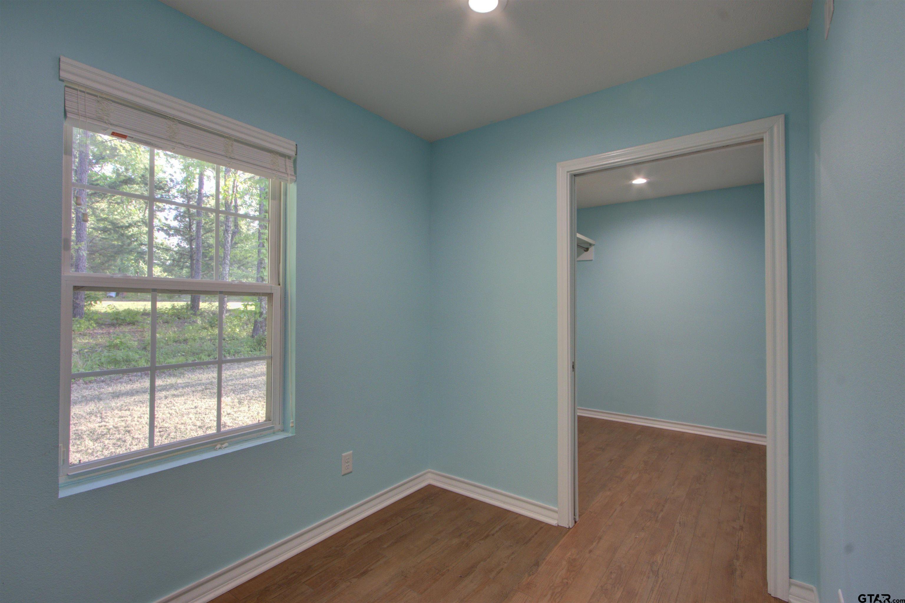 720 Tennessee Acres Drive Texarkana Ar, AR 71854 - Photo 21 of 31 an empty room with wooden floor and windows