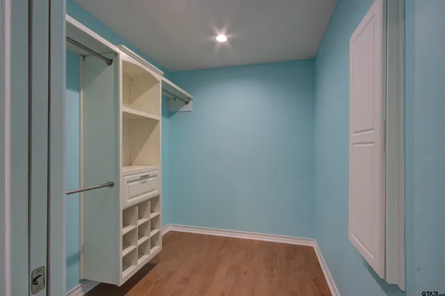 an empty room with wooden floor and closet