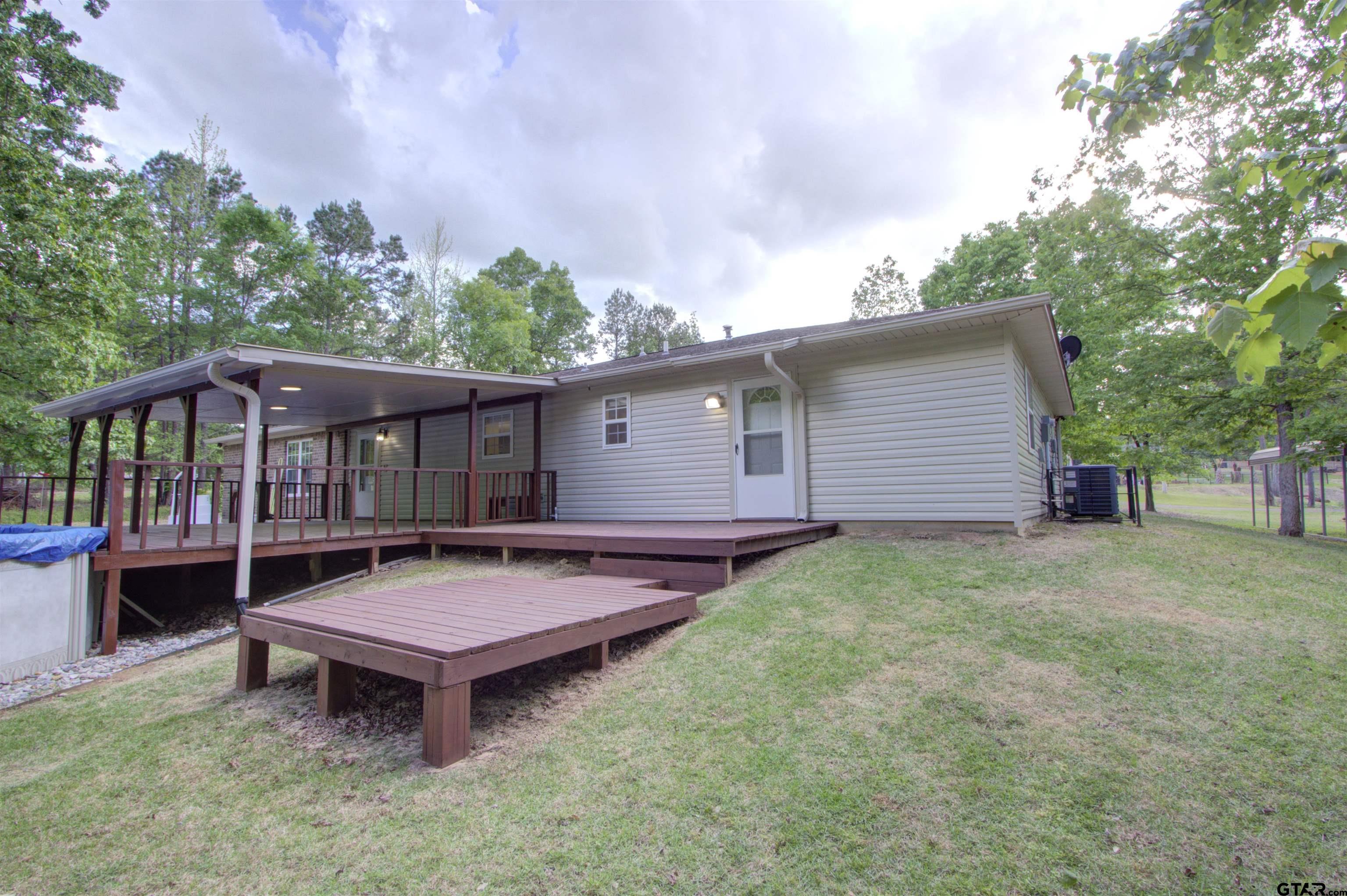 720 Tennessee Acres Drive Texarkana Ar, AR 71854 - Photo 25 of 31 a view of a house with a backyard and a patio