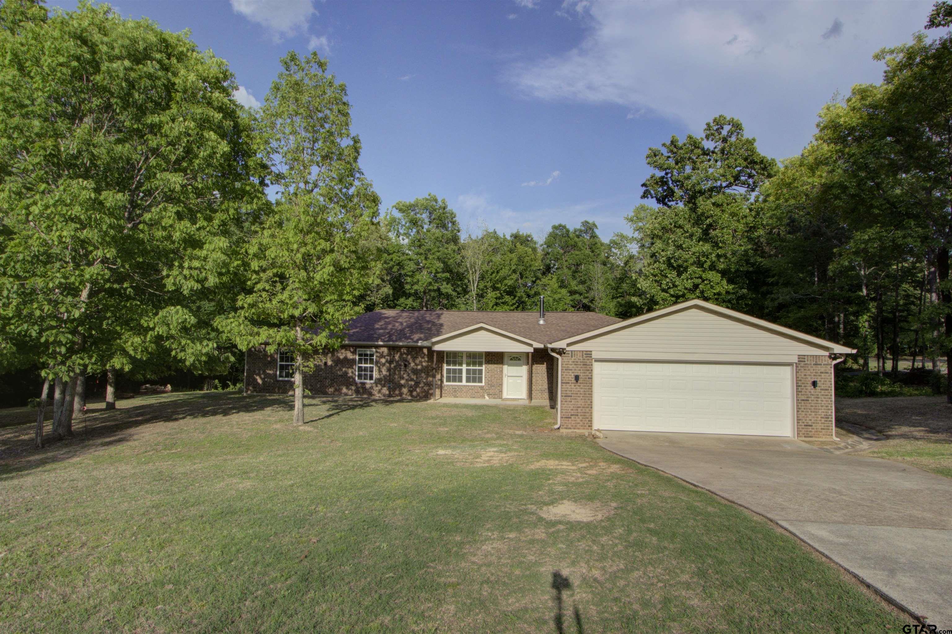 720 Tennessee Acres Drive Texarkana Ar, AR 71854 - Photo 3 of 31 a front view of a house with a yard and garage