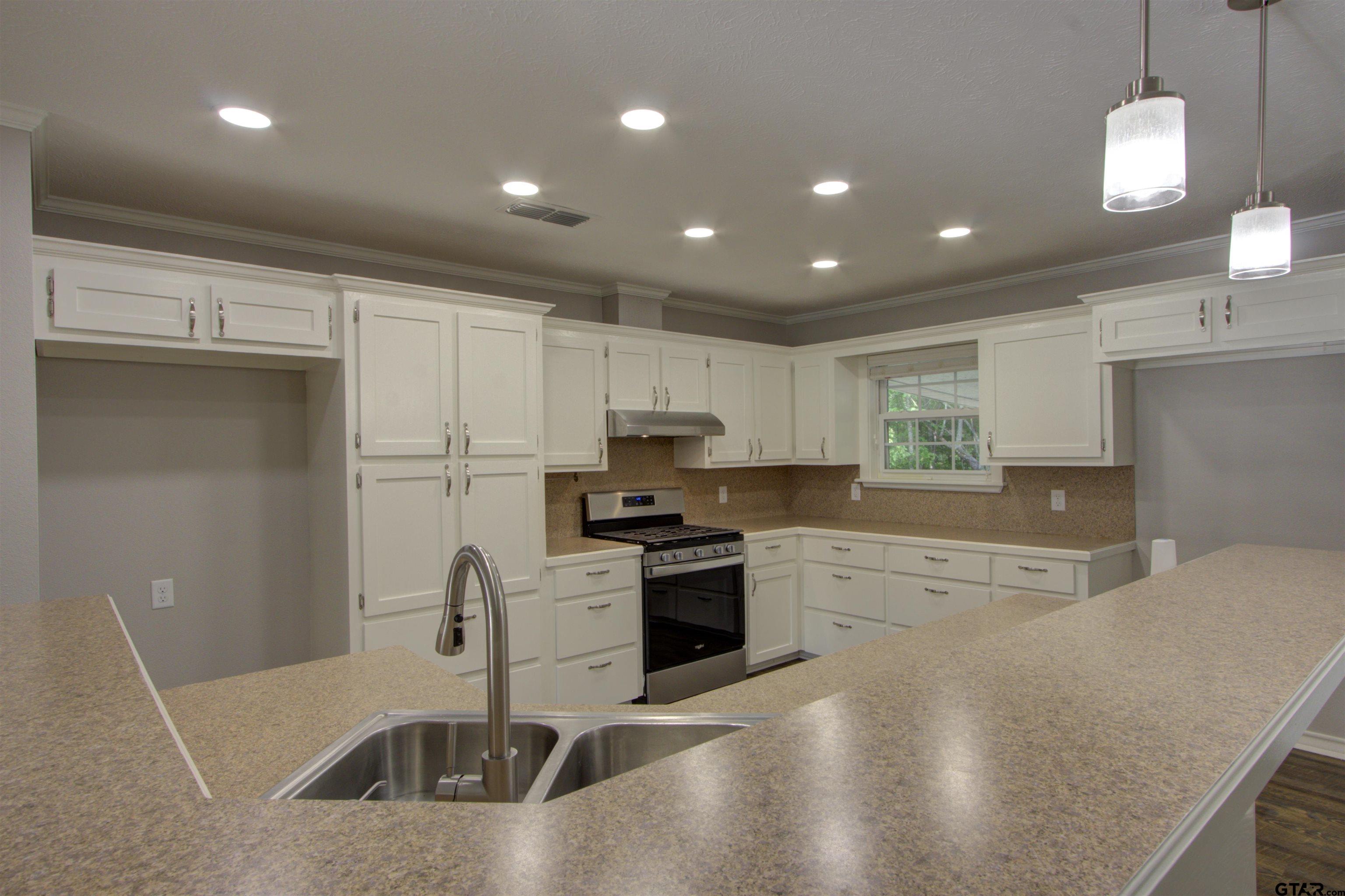 720 Tennessee Acres Drive Texarkana Ar, AR 71854 - Photo 5 of 31 a kitchen with stainless steel appliances granite countertop a sink a stove and a refrigerator