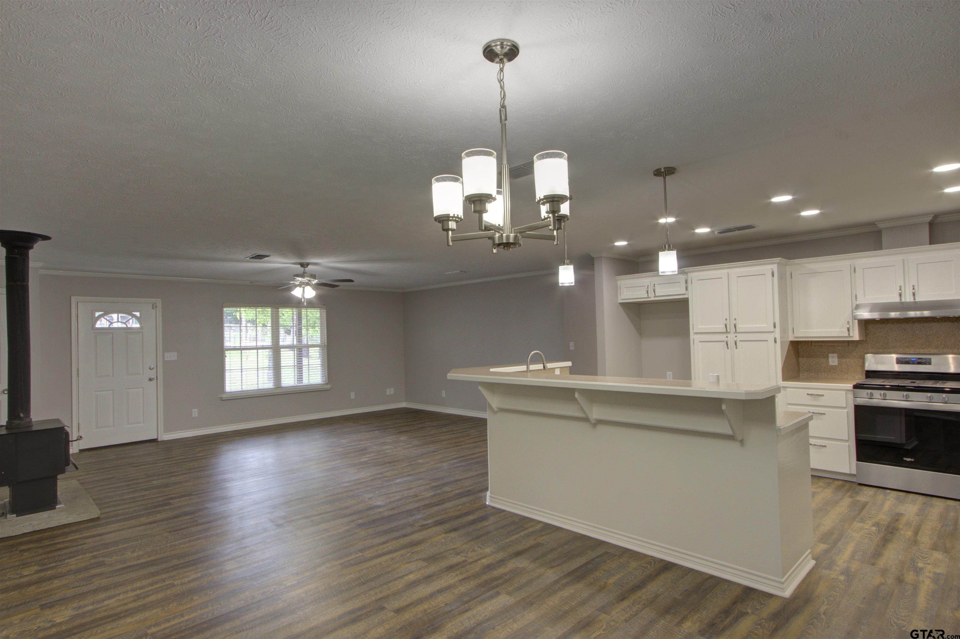 720 Tennessee Acres Drive Texarkana Ar, AR 71854 - Photo 9 of 31 a kitchen with stainless steel appliances granite countertop a stove top oven a sink dishwasher a oven and a dining table with wooden floor