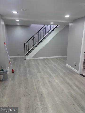 a view of room with stairs and wooden floor