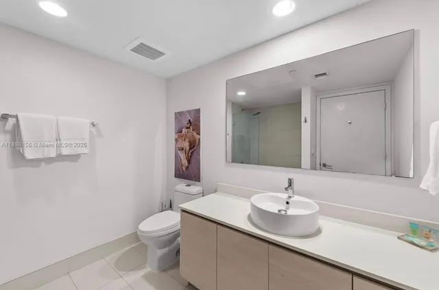 a view of a hallway to a livingroom with furniture and workspace