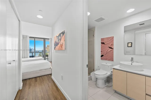 a bedroom with a bed and a lamp