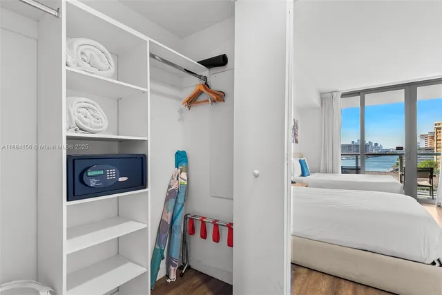 a bedroom with two beds and a desk