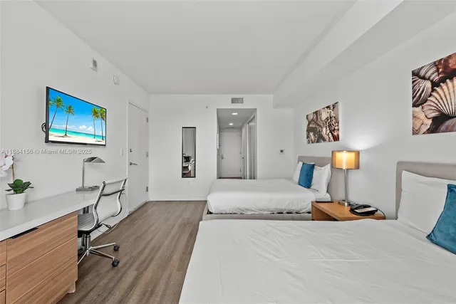 a bedroom with a bed and a large window