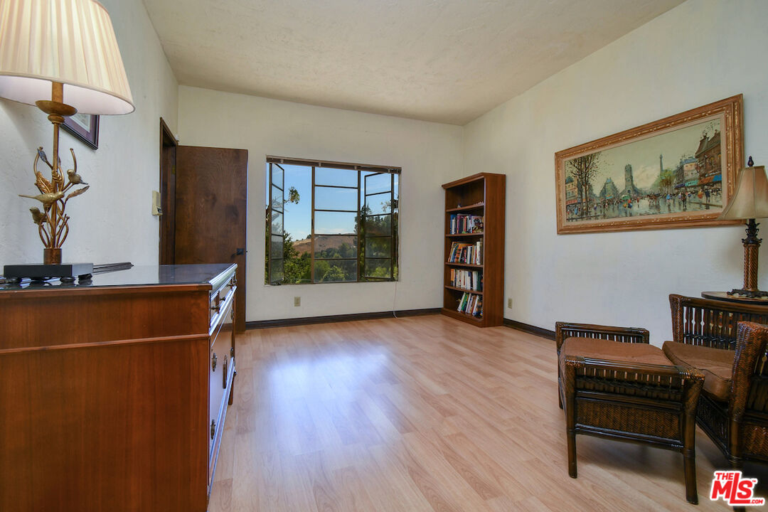 24926 Jim Bridger Road Hidden Hills, CA 91302 - Photo 17 of 28 a view of room with window and wooden floor
