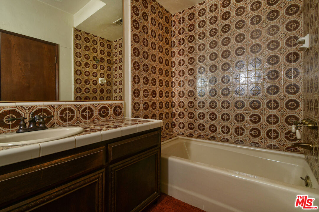 24926 Jim Bridger Road Hidden Hills, CA 91302 - Photo 19 of 28 a bathroom with a bathtub and shower