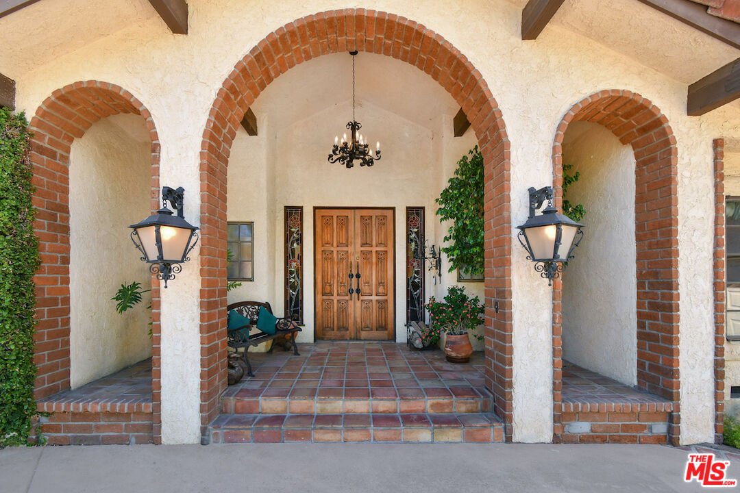 24926 Jim Bridger Road Hidden Hills, CA 91302 - Photo 3 of 28 a front view of a house