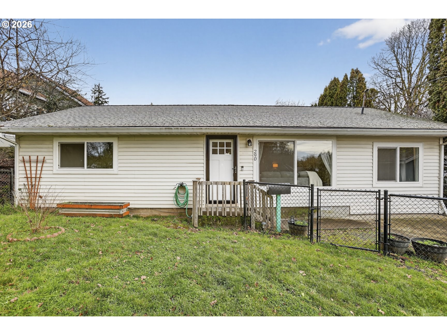 a backyard of a house with table and chairs