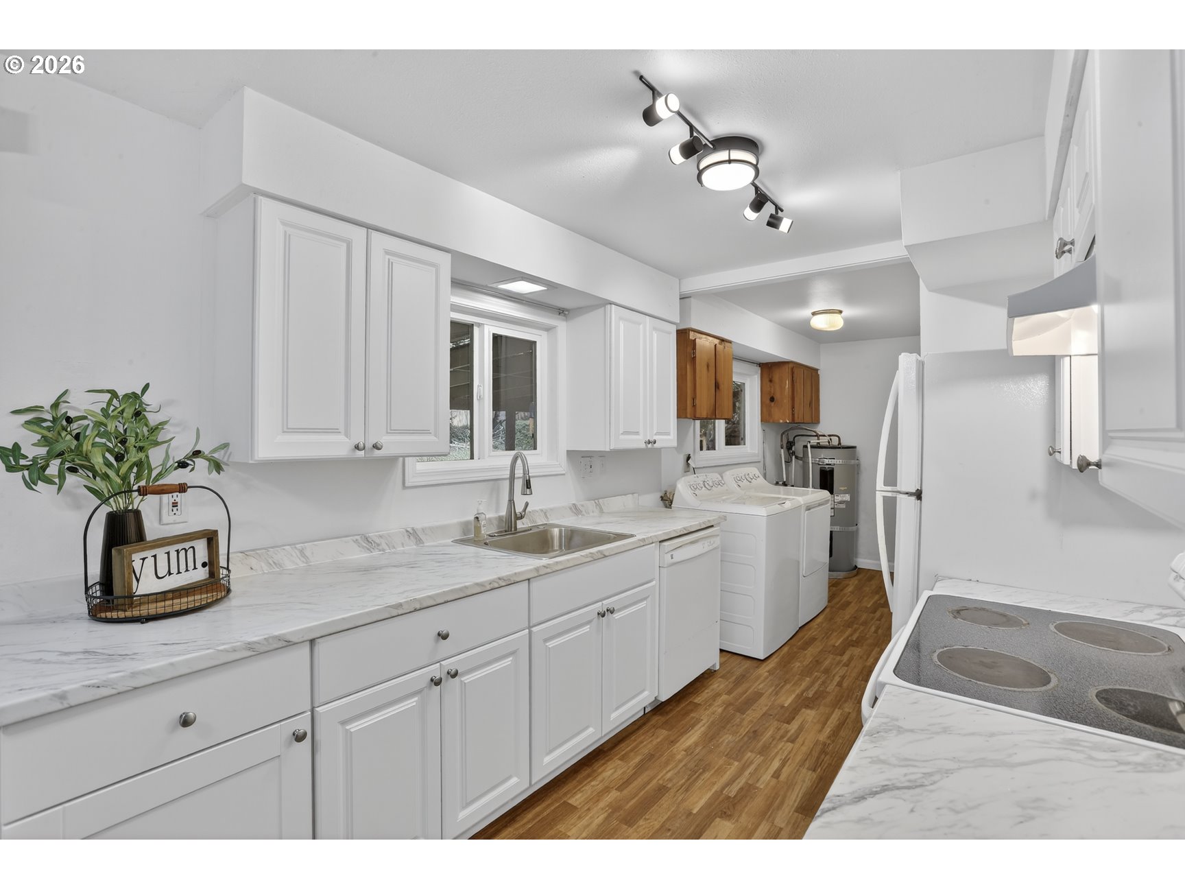 290 North 4th Street St. Helens, OR 97051 - Photo 12 of 26 a kitchen with a sink dishwasher and white cabinets