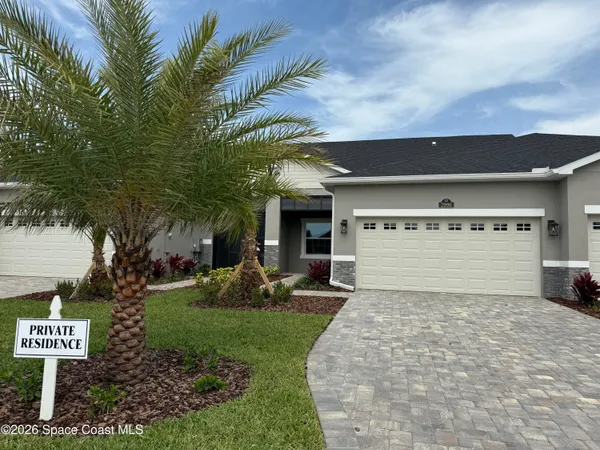 a view of a house with a yard and garage