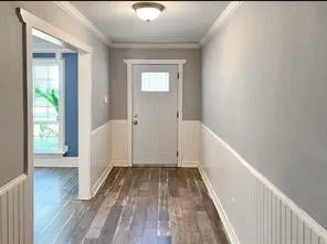 a view of hallway with wooden floor
