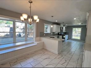 17715 Loring Lane Spring, TX 77388 - Photo 6 of 11 a view of a kitchen with granite countertop a large window and a chandelier