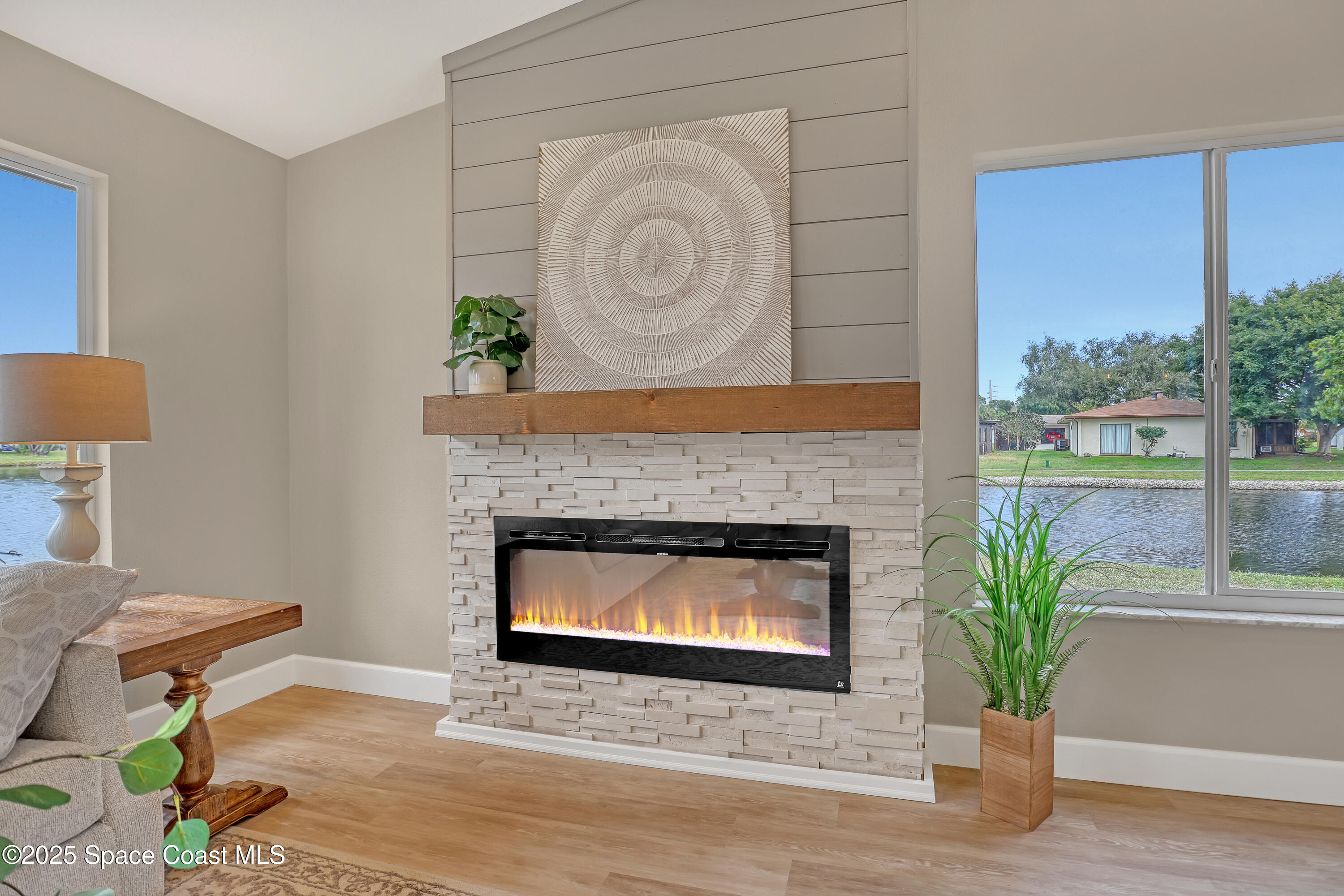443 Myrtlewood Road Melbourne, FL 32940 - Photo 14 of 72 a living room with a fireplace and a potted plant