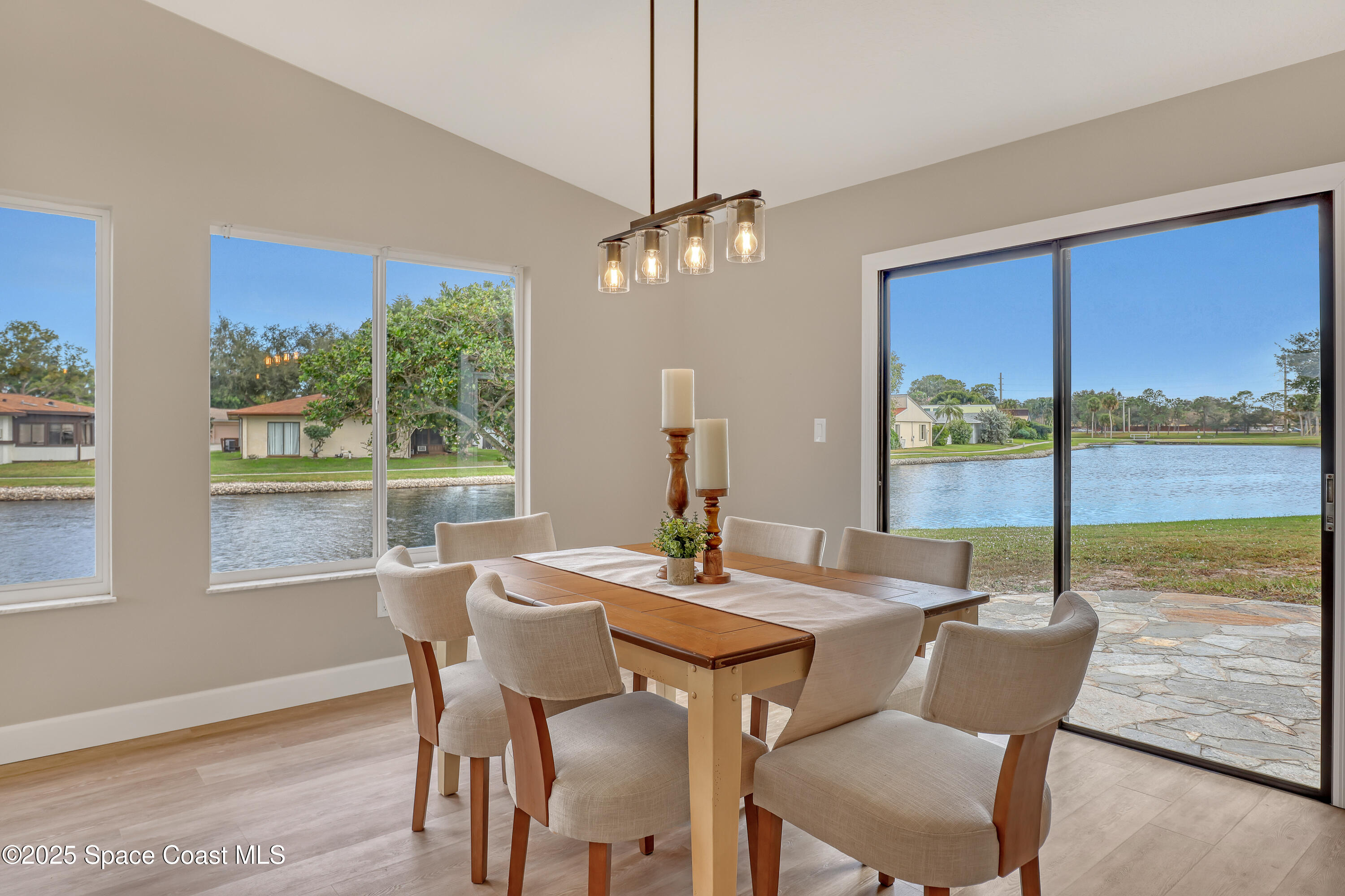 443 Myrtlewood Road Melbourne, FL 32940 - Photo 16 of 72 a view of a dining room with furniture large windows and wooden floor